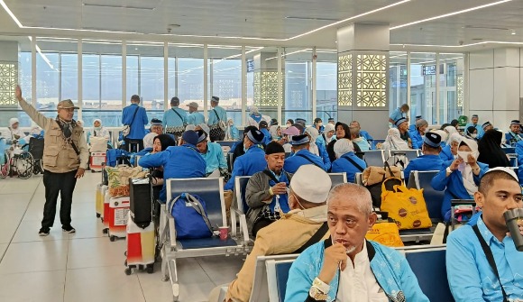 Jemaah haji Kloter 28 SOC Semarang memakai seragam batik biru saat menunggu proses boarding di ruang tunggu Bandara King Abdul Aziz Jeddah sebelum pemulangan ke tanah air.