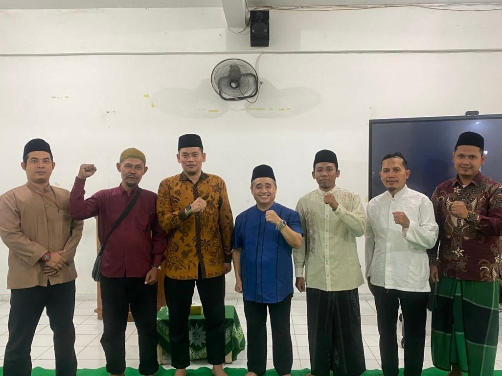 Tujuh orang inisiator gerakan Qori Muhammadiyah mengepalkan tangan dan berfoto bersama Ketua PWM Jawa Tengah KH Tafsir saat pertemuan perdana di aula sekolah.